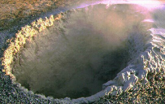 Crater spewing fumes and hot mud