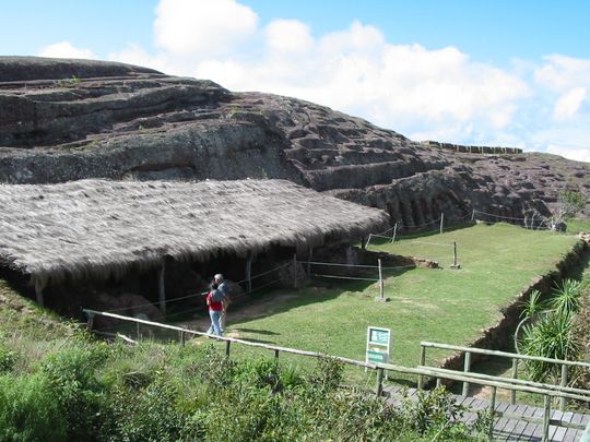 Reconstructed homes at the foot of the fortress